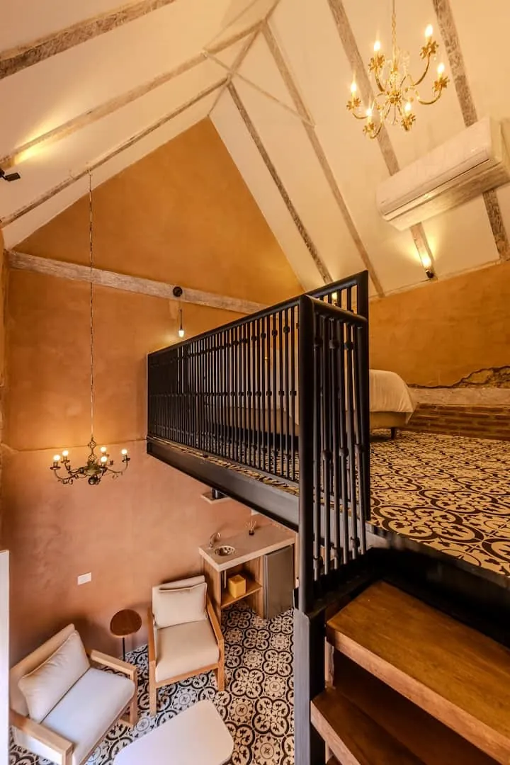 Nivel superior de la Duplex Luxury con barandal de hierro y muros en terracota.